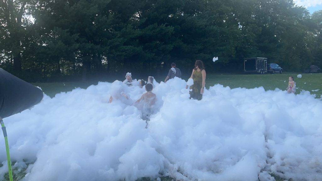 People playing in foam bubbles.